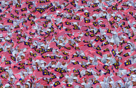 KUALA LUMPUR, MALAYSIA - AUGUST 31, 2014: Student waving Malaysia flag 'Jalur Gemilang' during Independent Day celebration in Kuala Lumpur.のeditorial素材