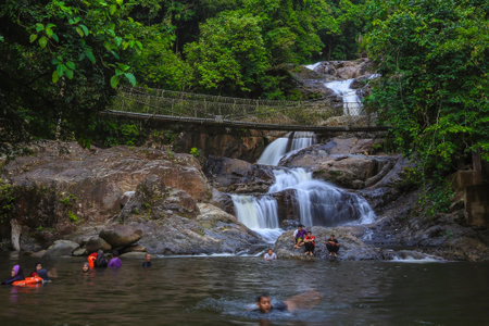 KENYIR LAKE, MALAYSIA - AUGUST 27, 2016 : Tourist enjoy the beautiful of Lasir waterfall, Kenyir Lake, Terengganu. Lasir waterfall also known as Air Terjun Lasir.のeditorial素材
