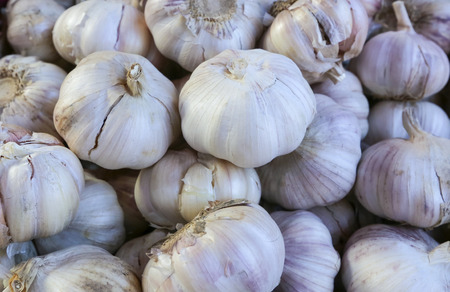 Stack of garlic on display at market.