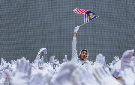 KUALA LUMPUR, MALAYSIA - AUGUST 31, 2016 : Student waving Malaysia flag also known as Jalur Gemilang on Independence Day celebration or Merdeka Day.のeditorial素材