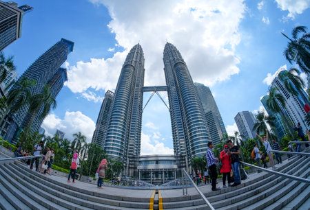 KUALA LUMPUR, MALAYSIA : JANUARY 10, 2015 : Tourist taking a picture with the background of Petronas Twin Towers.のeditorial素材