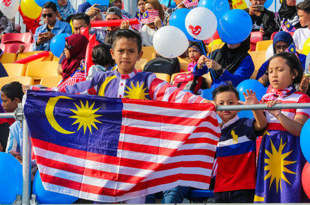 KUALA LUMPUR, MALAYSIA - AUGUST 31, 2016 : Kids waving Malaysia flag also known as Jalur Gemilang during Independence Day celebration or Merdeka Day at Merdeka Square.のeditorial素材