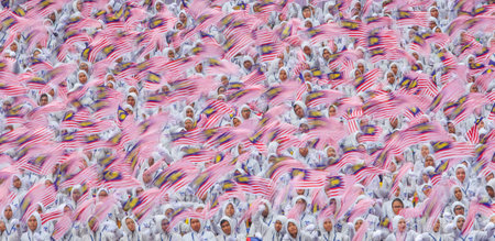 KUALA LUMPUR, MALAYSIA - AUGUST 31, 2016 : Slow motion effect of student waving Malaysia flag also known as Jalur Gemilang during Independence Day celebration or Merdeka Day at Merdeka Square.のeditorial素材