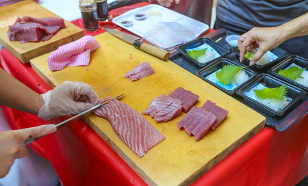 Fresh Tuna fish cut by professional Japanese chef to sliced Tuna fillet. Tuna can be a good source of omega - 3 fatty acids.の写真素材