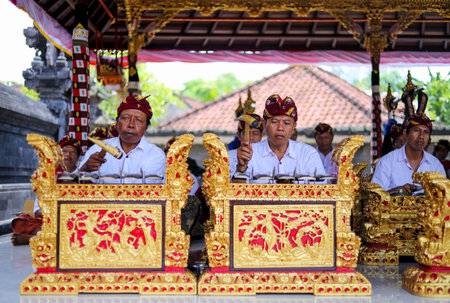 BALI, INDONESIA - NOVEMBER 15, 2017 : Balinese men playing traditional Balinese music instrument gamelan during religious ceremony at Tanah Lot temple, Bali.のeditorial素材