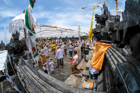 BALI, INDONESIA - NOVEMBER 15, 2017 : Balinese people in traditional clothes during religious ceremony at Tanah Lot temple, Bali.のeditorial素材