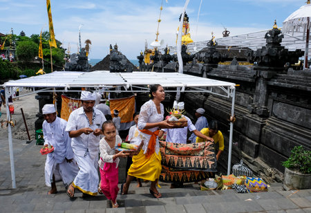 BALI, INDONESIA - NOVEMBER 15, 2017 : Balinese people in traditional clothes during religious ceremony at Tanah Lot temple, Bali.のeditorial素材