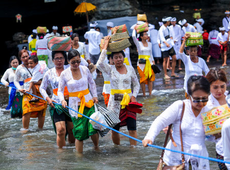 BALI, INDONESIA - NOVEMBER 15, 2017 : Balinese people in traditional clothes during religious ceremony at Tanah Lot temple, Bali.のeditorial素材