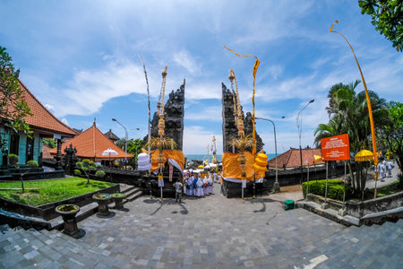 BALI, INDONESIA - NOVEMBER 15, 2017 : Balinese people in traditional clothes during religious ceremony at gate of Tanah Lot temple, Bali.のeditorial素材