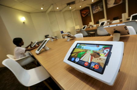 KUALA LUMPUR, MALAYSIA - AUGUST 07, 2018 : Smart library for reading ebook using computer tablet. Future technology for reading book.のeditorial素材