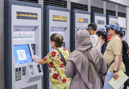 KUALA LUMPUR, MALAYSIA : JULY 17, 2017 : Passenger buying ticket from vending machines located at Bukit Bintang Mass Rapid Transit (MRT) stations.のeditorial素材