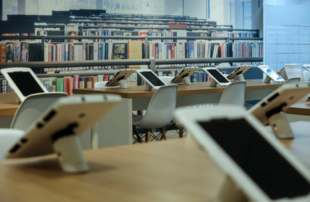 KUALA LUMPUR, MALAYSIA - AUGUST 07, 2018 : Smart library for reading ebook using computer tablet. Future technology for reading book.のeditorial素材
