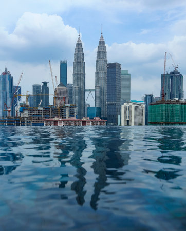 KUALA LUMPUR, MALAYSIA - JULY 18, 2018 : Swimming pool with background view of Petronas Twin Tower...