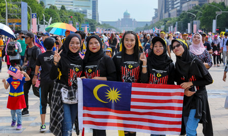 PUTRAJAYA, MALAYSIA - AUGUST 31, 2018 : Malaysian waving Jalur Gemilang flag during National Day celebration parade in Putrajaya. Celebrating the 61th anniversary of independence or Merdeka Day.のeditorial素材