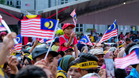 PUTRAJAYA, MALAYSIA - AUGUST 31, 2018 : Malaysian waving Jalur Gemilang flag during National Day celebration parade in Putrajaya. Celebrating the 61th anniversary of independence or Merdeka Day.のeditorial素材