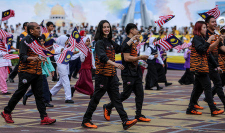PUTRAJAYA, MALAYSIA - AUGUST 31, 2018 : Participant waving Jalur Gemilang flag during National Day celebration parade in Putrajaya. Celebrating the 61th anniversary of independence or Merdeka Day.のeditorial素材