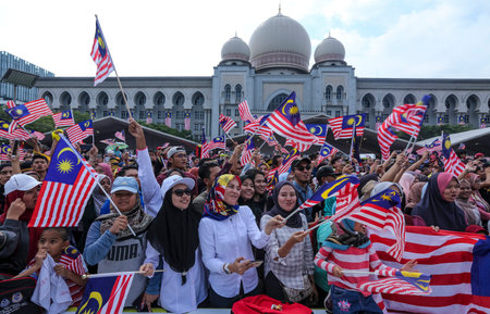 PUTRAJAYA, MALAYSIA - AUGUST 31, 2018 : Malaysian waving Jalur Gemilang flag during National Day celebration parade in Putrajaya. Celebrating the 61th anniversary of independence or Merdeka Day.のeditorial素材