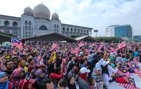 PUTRAJAYA, MALAYSIA - AUGUST 31, 2018 : Malaysian waving Jalur Gemilang flag during National Day celebration parade in Putrajaya. Celebrating the 61th anniversary of independence or Merdeka Day.のeditorial素材