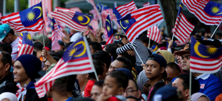 PUTRAJAYA, MALAYSIA - AUGUST 31, 2018 : Malaysian waving Jalur Gemilang flag during National Day celebration parade in Putrajaya. Celebrating the 61th anniversary of independence or Merdeka Day.のeditorial素材