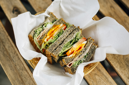 Black Sesame Toast Sandwich. Bread with chicken, egg and vegetables, a healthy style breakfast.の写真素材