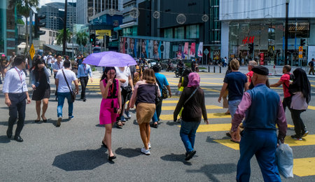 KUALA LUMPUR, MALAYSIA : OCTOBER 25, 2018 : People crossing road at MRT (Mass Rapid Transit) Bukit Bintang station. Bukit Bintang is a tourist attraction place for shopping, eat and sightseeing.のeditorial素材