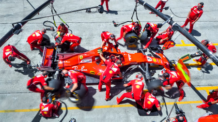 SEPANG, MALAYSIA : SEPTEMBER 30, 2017 : Team members of Kimi Raikkonen of Scuderia Ferrari practice a pit stop ahead of the Malaysia Formula One (F1) Grand Prix at Sepang International Circuit (SIC).のeditorial素材
