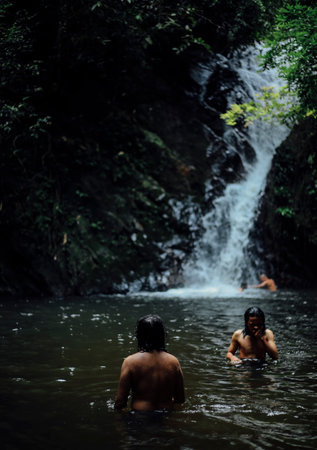 PERAK, MALAYSIA - JULY 11, 2018 : Tourist enjoying waterfall while discovering peace nature environment of 130 million years old Royal Belum Rainforest Park at Temengor Lake.のeditorial素材