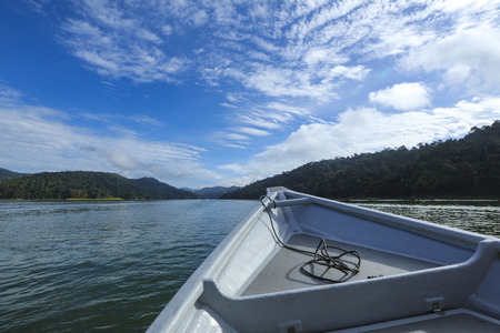 The peace environment and rainforest landscape of Royal Belum State Park reflected off the calm waters of Temengor Lake at Pulau Banding, Perak.の写真素材