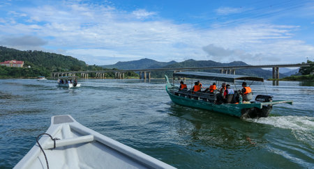PERAK, MALAYSIA - JULY 10, 2018 : Tourist enjoying a boat ride to discover peace environment of 130 million years old Royal Belum Rainforest Park acrossing the Temengor Lake at Pulau Banding, Perak.のeditorial素材