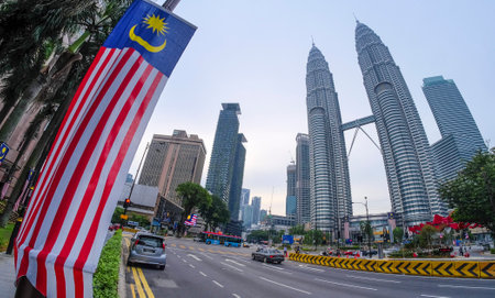 KUALA LUMPUR, MALAYSIA - SEPTEMBER 17, 2016 : View of Petronas Twin Towers with Malaysia flag, Jalur Gemilang. Petronas Twin Towers also known as KLCC (Kuala Lumpur City Centre).のeditorial素材