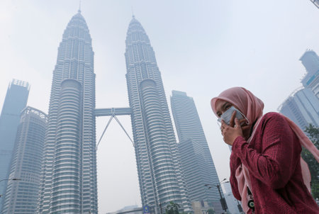KUALA LUMPUR, MALAYSIA - SEPTEMBER 13, 2019 : A Women cover his nose and mouth with mask during haze...