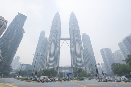 KUALA LUMPUR, MALAYSIA - SEPTEMBER 13, 2019 : The Petronas Twin Towers and other buildings stand...