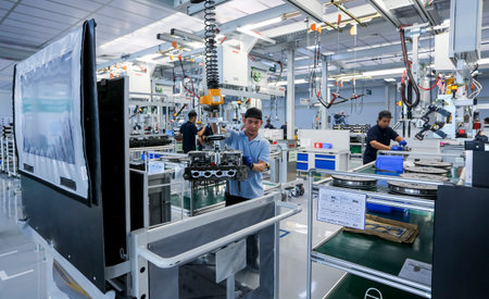 KEDAH, MALAYSIA - JULY 04, 2019 : Workers at engine assembly plant. Catering for both the domestic...