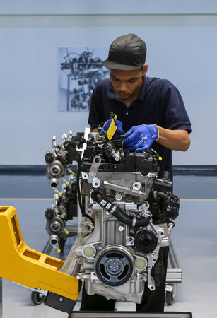 KEDAH, MALAYSIA - JULY 04, 2019 : Workers at engine assembly plant. Catering for both the domestic...