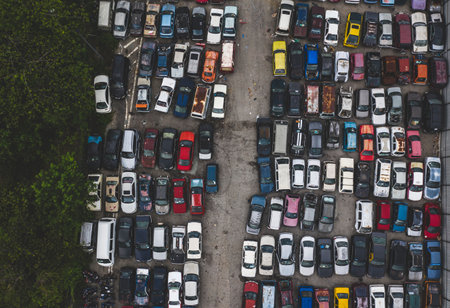 KUALA LUMPUR, MALAYSIA - SEPTEMBER 27, 2019 : Top view of unuse, unclaim, old damaged cars and other vehicle at junkyard waiting for recycling. Industrial scrap and transportation.のeditorial素材