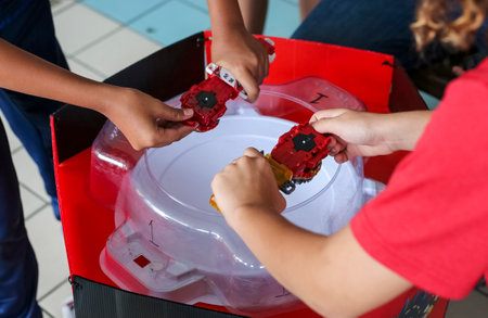 KUALA LUMPUR, MALAYSIA - OCTOBER 06, 2019 : Kids playing Beyblade toys. Beyblade is a line of...