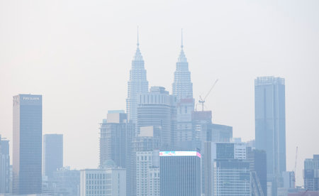 KUALA LUMPUR, MALAYSIA - AUGUST 01, 2019 : The Petronas Twin Towers and other buildings stand...
