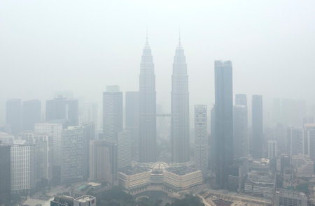 KUALA LUMPUR, MALAYSIA - SEPTEMBER 13, 2019 : The Petronas Twin Towers and other buildings stand shrouded in haze because of unhealthy air quality as smoke from raging forest fires in Indonesia.のeditorial素材