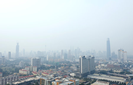 KUALA LUMPUR, MALAYSIA - SEPTEMBER 14, 2019 : Kuala Lumpur city centre buildings stand shrouded in haze because of unhealthy air quality as smoke from raging forest fires in Indonesia.のeditorial素材