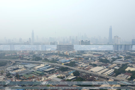KUALA LUMPUR, MALAYSIA - SEPTEMBER 20, 2019 : Kuala Lumpur city centre buildings stand shrouded in haze because of unhealthy air quality as smoke from raging forest fires in Indonesia.のeditorial素材