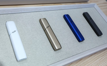 KUALA LUMPUR, MALAYSIA - OCTOBER 08, 2019 : Heating tobacco system IQOS by Philip Morris International. Electronic cigarette is new technology and alternative safe way in smoking.のeditorial素材