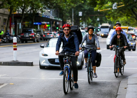 MELBOURNE, AUSTRALIA - MARCH 15, 2018 : Cyclist at Melbourne city center. People using bicycle for commute to work or food delivery.のeditorial素材