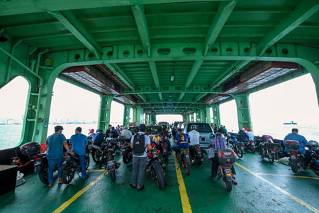 PENANG, MALAYSIA - FEBRUARY 15, 2020 : The famous Penang Ferry. Its carring passengers including car and motorcycle cruising between mainland and Island. Ferry is one of Penang tourism attractions.のeditorial素材