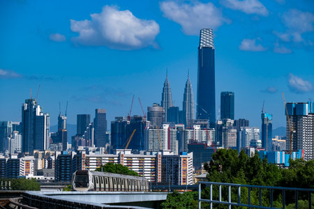 KUALA LUMPUR, MALAYSIA - FEBRUARY 21, 2020 : Malaysia MRT (Mass Rapid Transit) train with the background of Kuala Lumpur city. MRT is a transportation for future generation.のeditorial素材