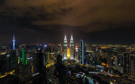 KUALA LUMPUR, MALAYSIA - MARCH 25, 2020 : Aerial view of Kuala Lumpur city center skyline with Petronas KLCC Twin Towers, KL Tower and surrounding building at night.のeditorial素材
