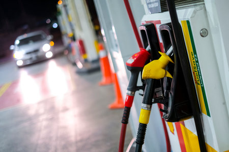 KUALA LUMPUR, MALAYSIA - MARCH 20, 2020: Petrol pump filling nozzles at Shell gas station. A filling station is a facility that sells gasoline, petrol and diesel fuel.のeditorial素材