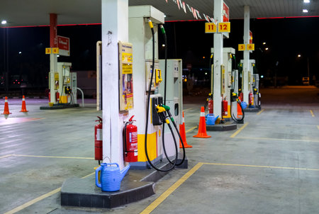 KUALA LUMPUR, MALAYSIA - MARCH 20, 2020: Petrol pump filling at Shell gas station. A filling station is a facility that sells gasoline, petrol and diesel fuel.のeditorial素材
