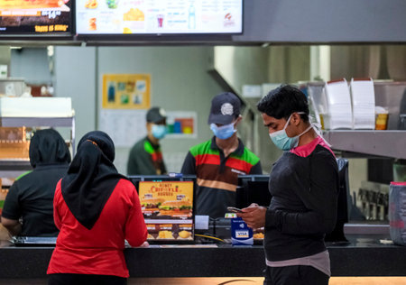 KUALA LUMPUR, MALAYSIA - MARCH 22, 2020: People wearing a face mask to prevent infection of the virus. Coronavirus disease 2019 (COVID-19) outbreak.のeditorial素材