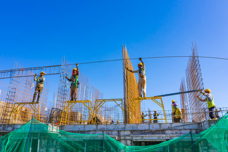 KUALA LUMPUR, MALAYSIA - MARCH 25, 2020: Construction workers work on high rise buildings at the...