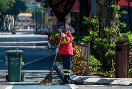 KUALA LUMPUR, MALAYSIA - APRIL 19, 2020: City cleaner worker still working during Movement Control Order (MCO) lockdown because of Coronavirus disease 2019 (COVID-19) outbreak.のeditorial素材